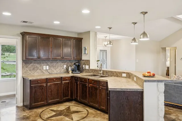 a kitchen with a sink a stove and cabinets