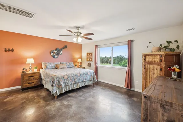 a bedroom with a bed and a window