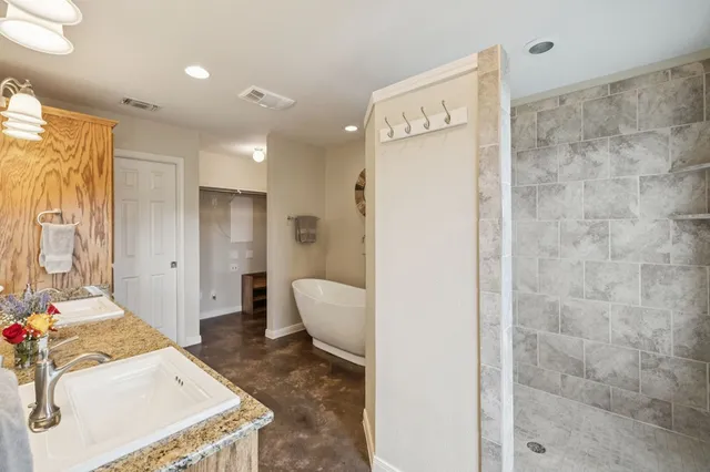 a spacious bathroom with a sink a mirror and a shower