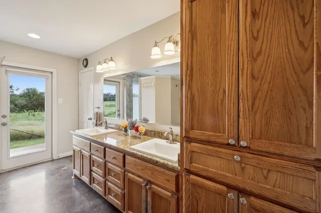a bathroom with a double vanity sink and a mirror