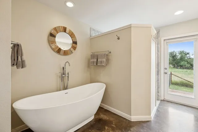a white bath tub sitting next to a bathroom