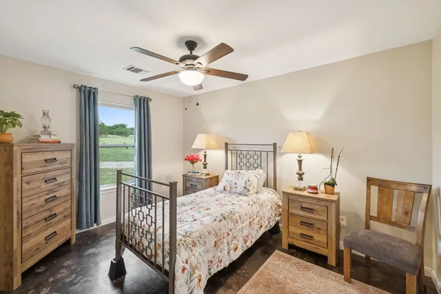 a bedroom with a bed and a dresser