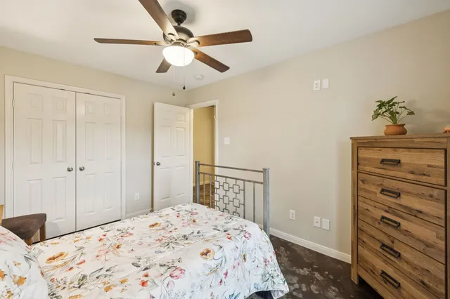 a bedroom with a bed and a dresser