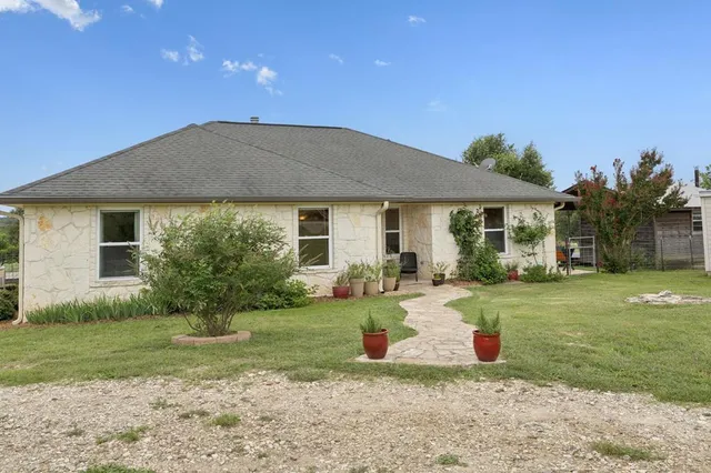 a front view of a house with garden
