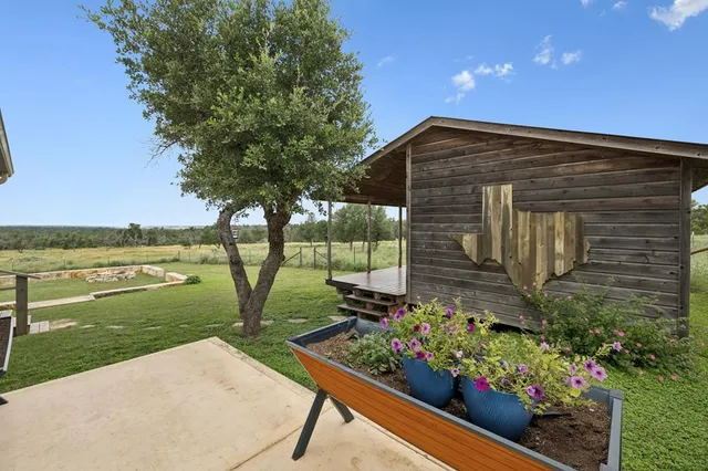 a backyard of a house with lots of green space and lake view