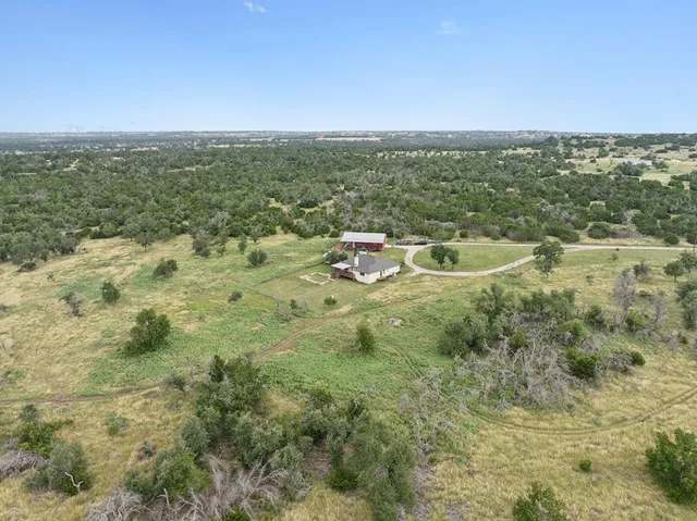 an aerial view of residential houses with city view