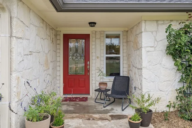 a view of a entryway door of the house with chairs