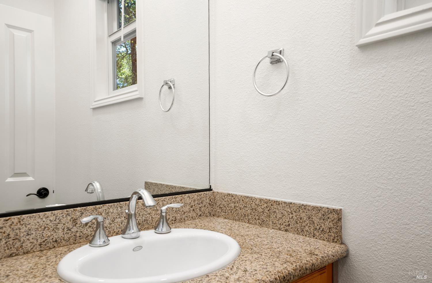 256 Rosebud Lane St. Helena, CA 94574 - Photo 14 of 33 a bathroom with a granite countertop sink and a mirror