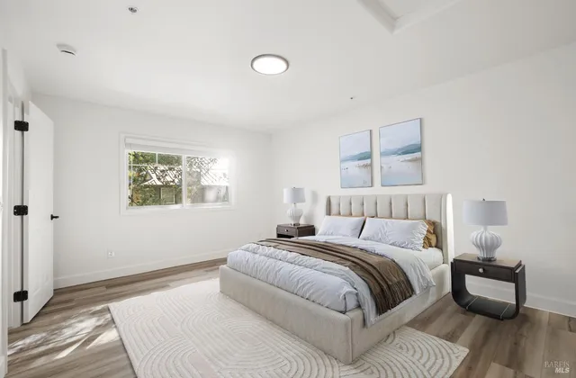 a view of a room with wooden floor and white walls