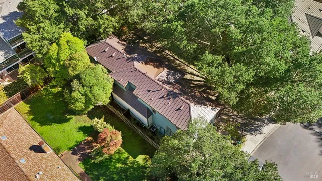 an aerial view of a house with a yard