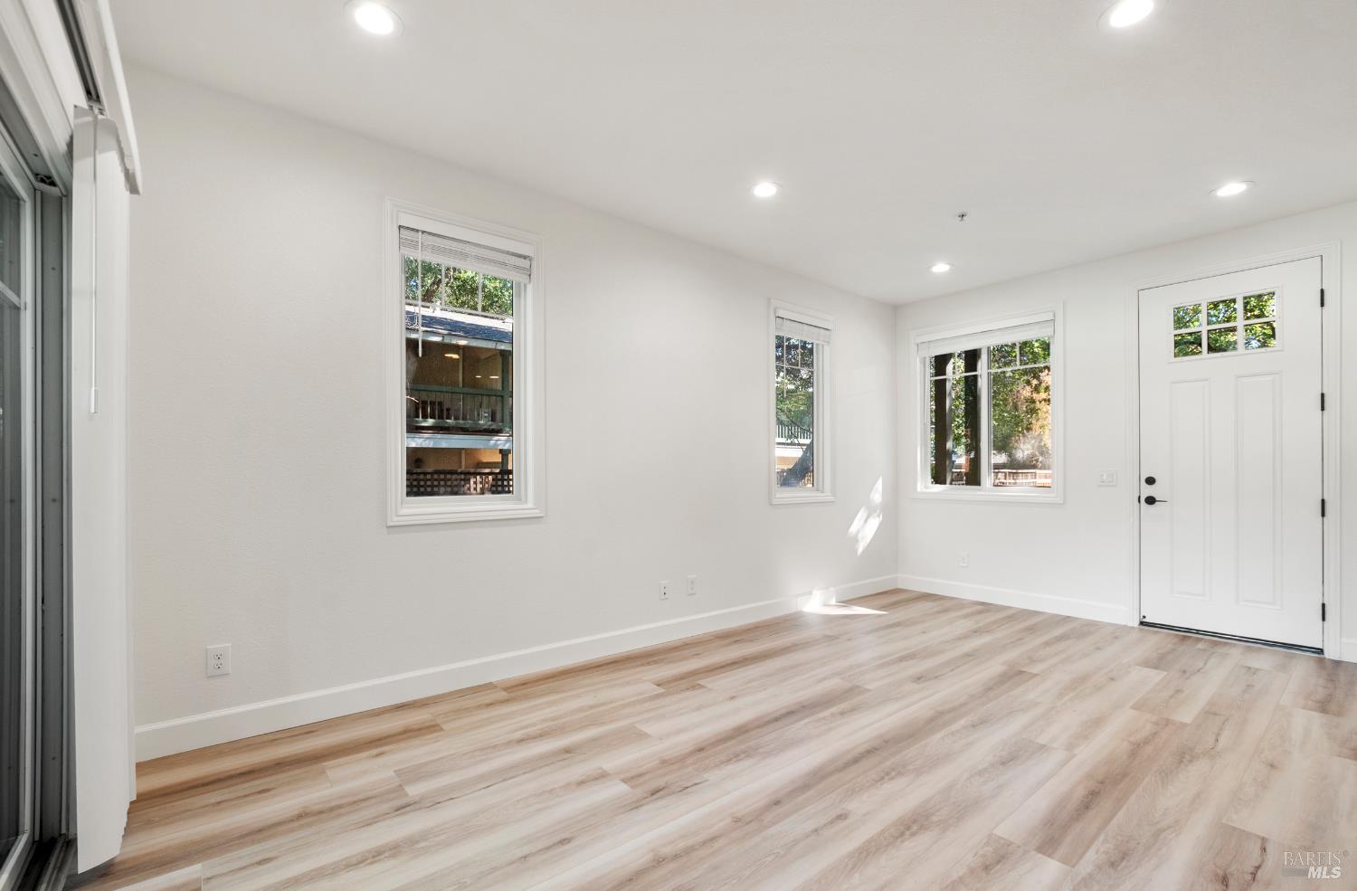 256 Rosebud Lane St. Helena, CA 94574 - Photo 6 of 33 an empty room with wooden floor and windows