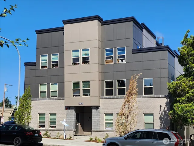a front view of a residential apartment building with a yard