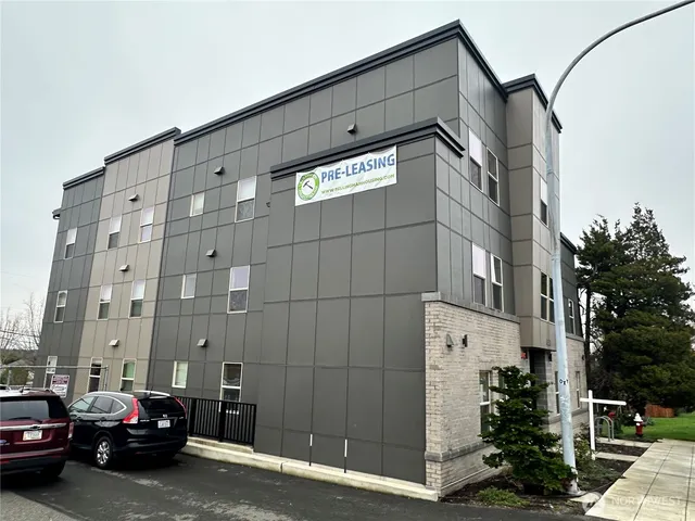 a view of a building and car parked in front of it