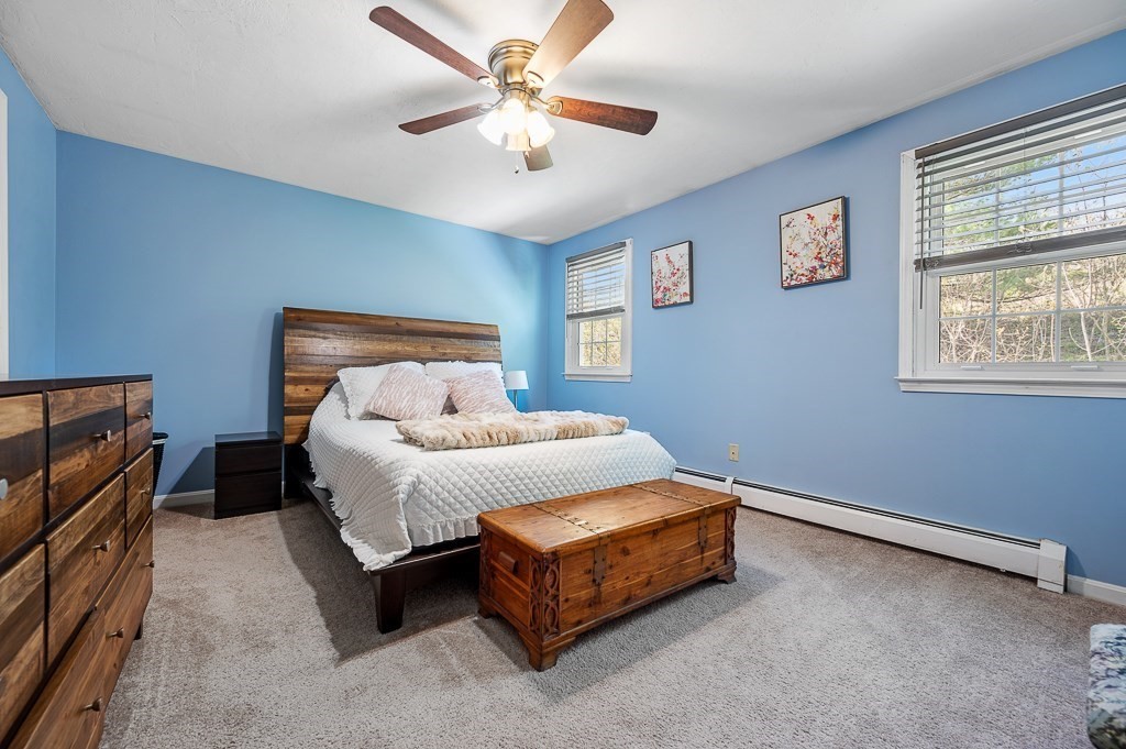 4 Tuck Farm Road, Unit 6 Auburn, MA 01501 - Photo 12 of 20 a spacious bedroom with a bed and a chandelier