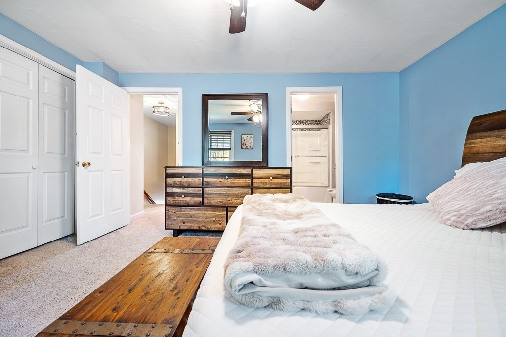 4 Tuck Farm Road, Unit 6 Auburn, MA 01501 - Photo 13 of 20 a bed room with a bed and mirror