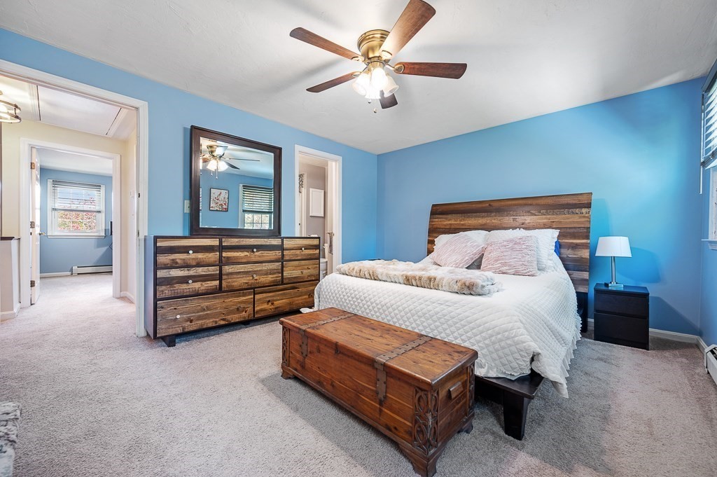 4 Tuck Farm Road, Unit 6 Auburn, MA 01501 - Photo 14 of 20 a bedroom with a bed and a chandelier