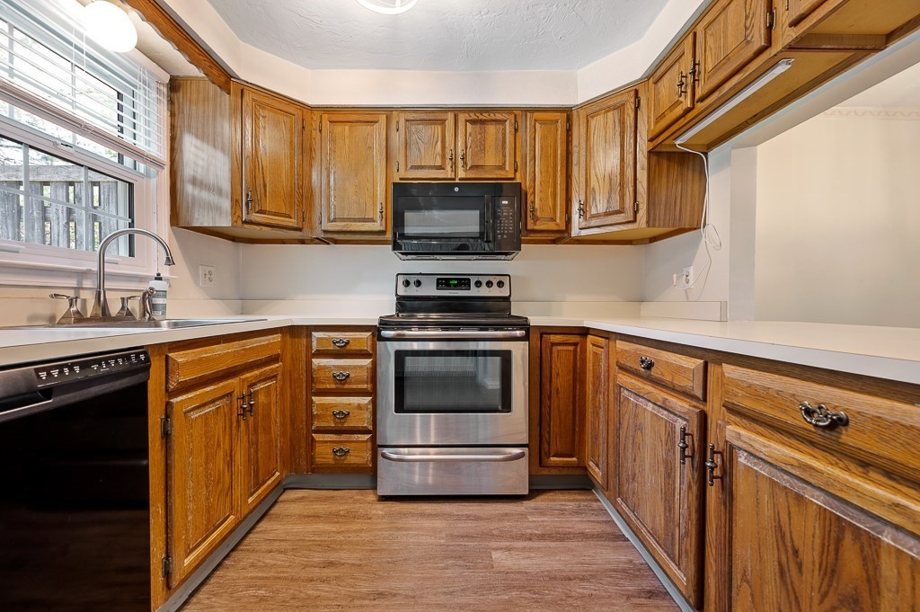 4 Tuck Farm Road, Unit 6 Auburn, MA 01501 - Photo 4 of 20 a kitchen with granite countertop a stove and a sink