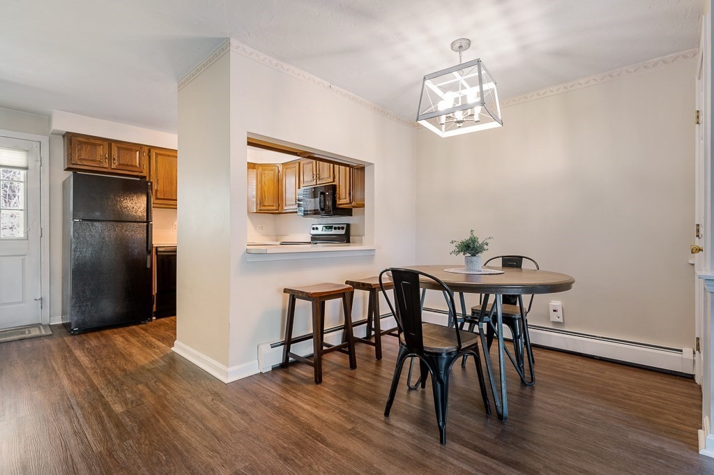 4 Tuck Farm Road, Unit 6 Auburn, MA 01501 - Photo 5 of 20 a view of a dining room with furniture wooden floor and a chandelier