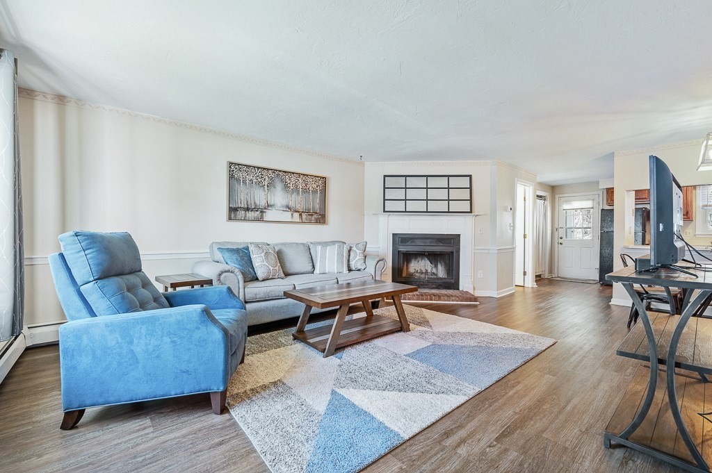 4 Tuck Farm Road, Unit 6 Auburn, MA 01501 - Photo 6 of 20 a living room with furniture and a fireplace
