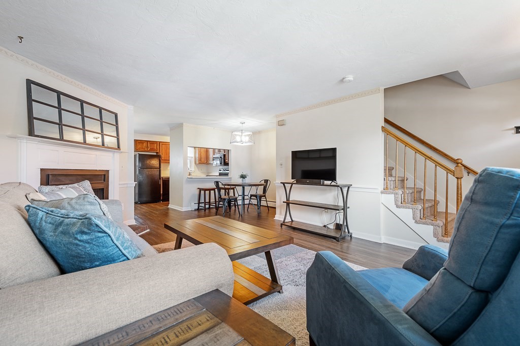 4 Tuck Farm Road, Unit 6 Auburn, MA 01501 - Photo 8 of 20 a living room with furniture and a flat screen tv