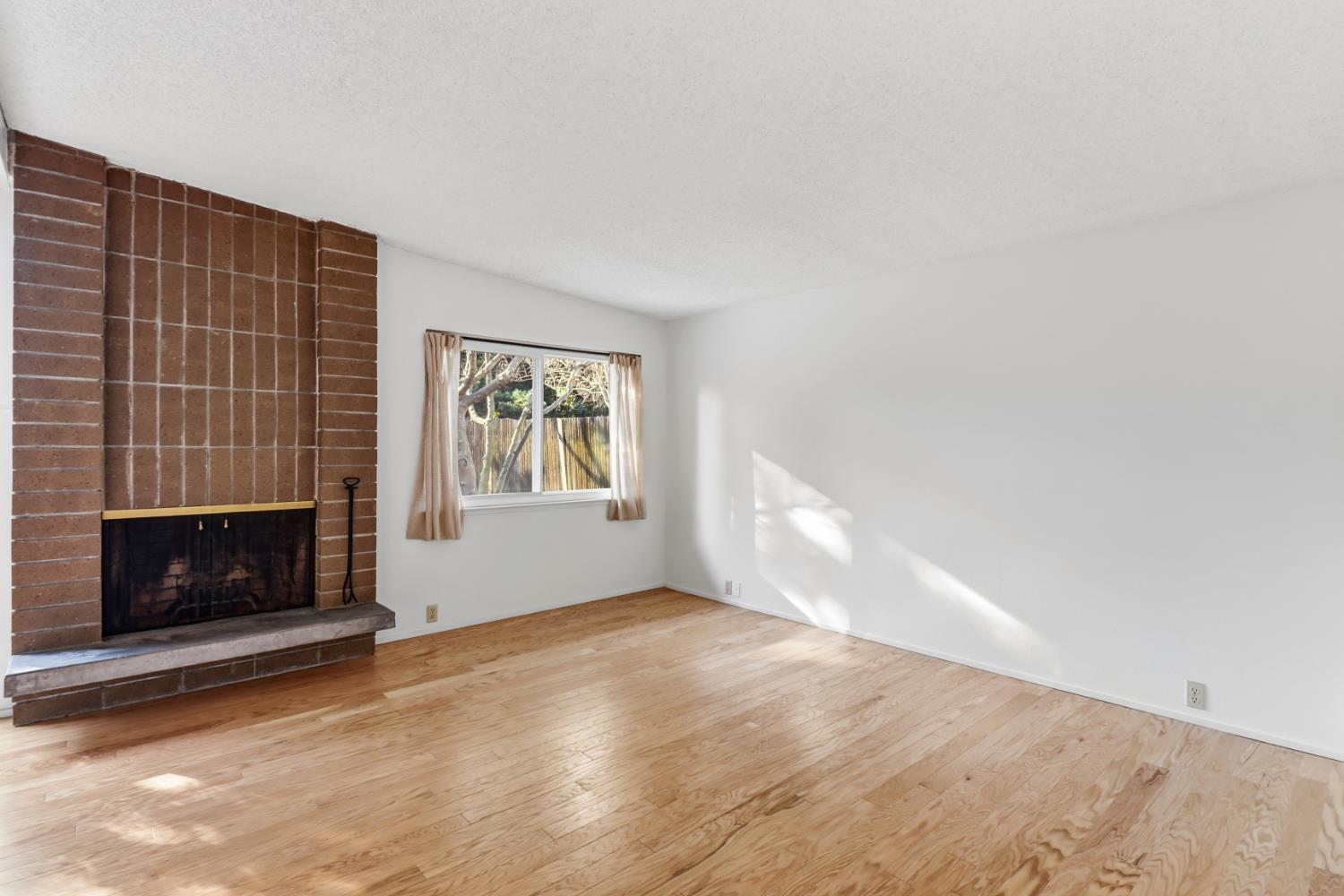 3216 Trawler Place Davis, CA 95616 - Photo 10 of 38 a view of empty room with a fireplace and wooden floor