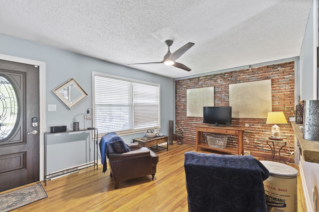 106 State Rd S-37-381 Seneca, SC 29678 - Photo 2 of 50 Living room with exposed brick wall