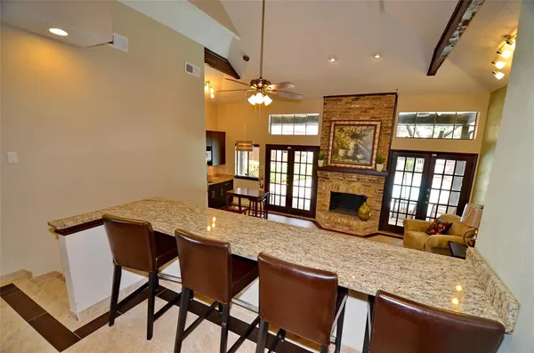 a kitchen with a table chairs sink and wooden floor