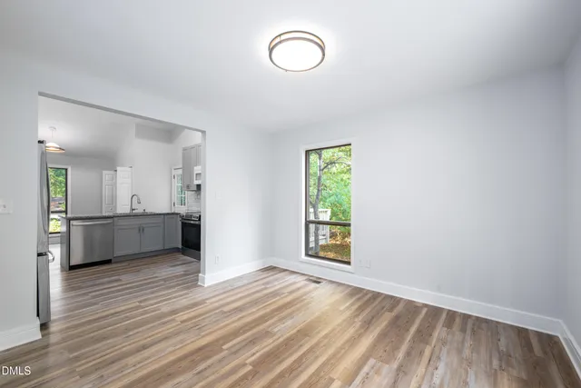 a bathroom with a toilet a sink a mirror and shower