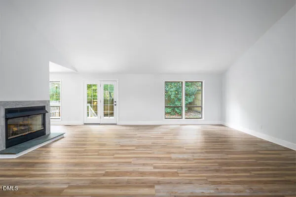 a kitchen with stainless steel appliances granite countertop a sink and dishwasher a stove top oven with wooden floor