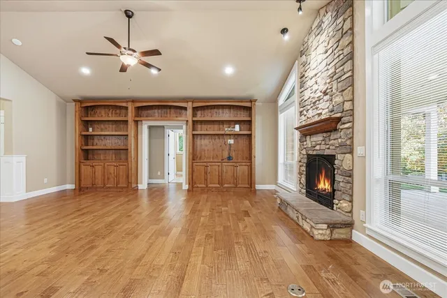 a view of an empty room with a fireplace and a window