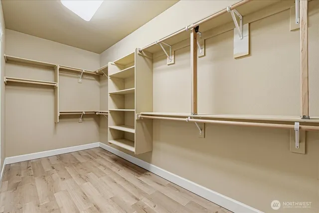 a view of walk in closet with empty racks