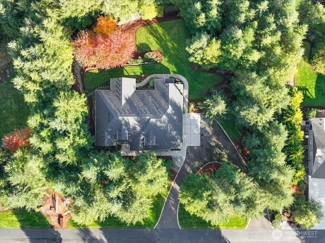 an aerial view of a house with a yard