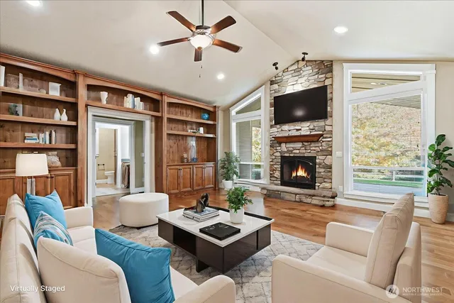 a living room with furniture a flat screen tv and a fireplace
