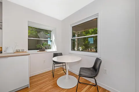 a dining room with furniture and window