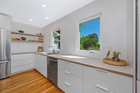 a kitchen with a sink cabinets and window