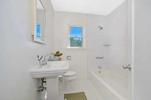 a bathroom with a sink a toilet and bathtub