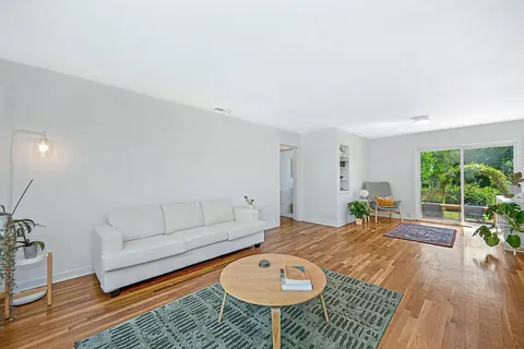 a living room with furniture a window and a table