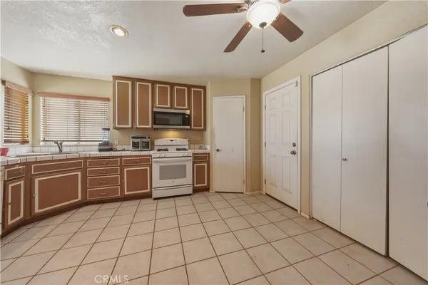 a kitchen with a stove a sink and a refrigerator