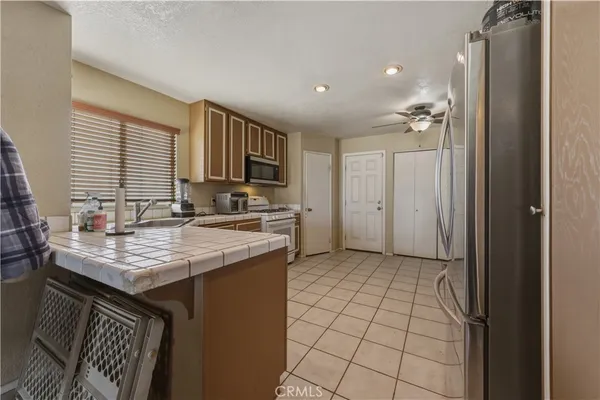 a kitchen with a sink a refrigerator and cabinets
