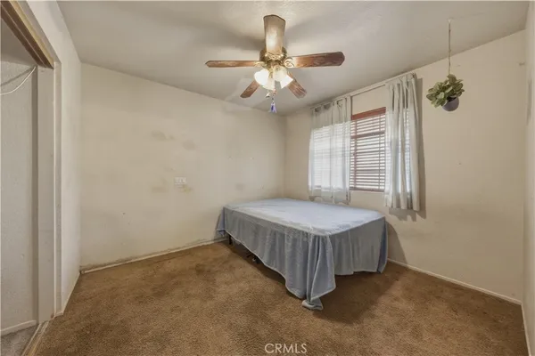 a bedroom with a bed and window