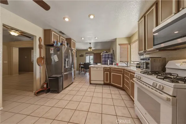 a kitchen with stainless steel appliances a refrigerator sink and cabinets