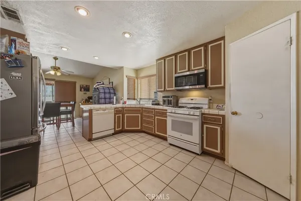 a kitchen with stainless steel appliances a refrigerator and a stove top oven