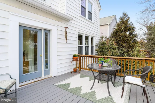a balcony with table and chairs