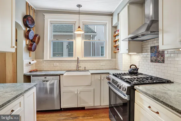 a kitchen with a sink stove and cabinets