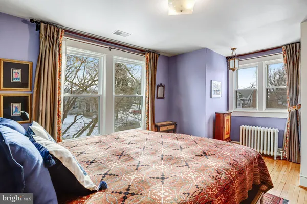 a bedroom with a large bed and a large window with outer view