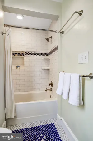 a bathroom with a shower and a bath tub