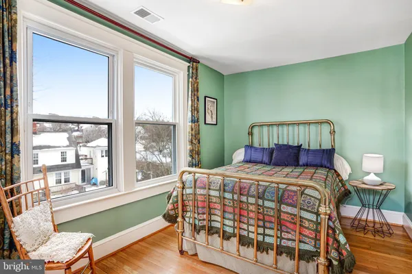 a bedroom with a bed and a chair