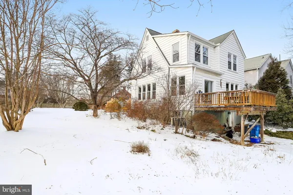 a view of a house with a wooden fence