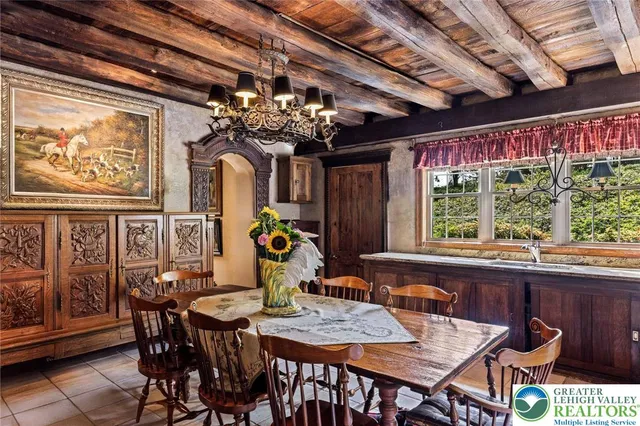 a view of a dining room with furniture a chandelier and fireplace