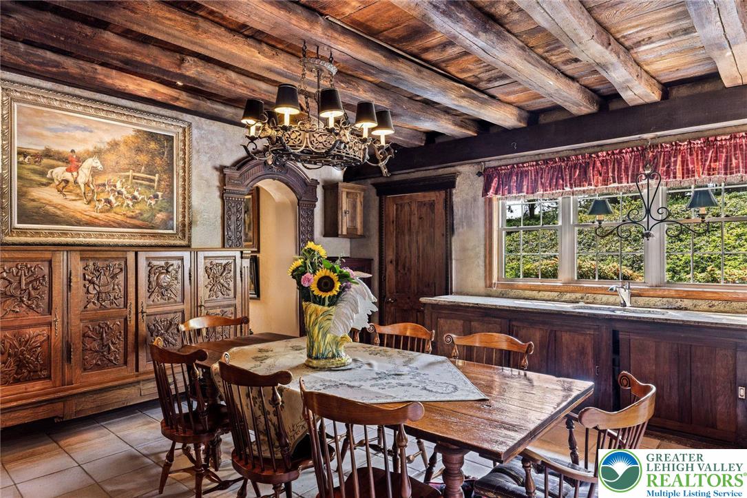 3791 Hunter Road Kintnersville, PA 18930 - Photo 14 of 55 a view of a dining room with furniture a chandelier and large windows